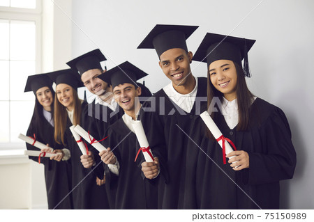 Group portrait of happy multiethnic university graduates holding diplomas and smiling Group portrait of happy multiethnic university graduates holding diplomas and smiling 75150989