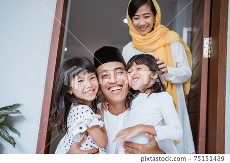 excited father hug and embrace his children during eid mubarak celebration excited father hug and embrace his children during eid mubarak celebration 75151489