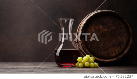 Wine decanter, grapes and old wooden barrel Wine decanter, grapes and old wooden barrel 75152224