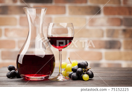 Wine decanter and glass of red wine Wine decanter and glass of red wine 75152225