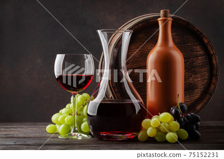 Wine bottle, decanter, glass and old wooden barrel 75152231