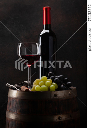 Wine bottle, glass and old wooden barrel Wine bottle, glass and old wooden barrel 75152232