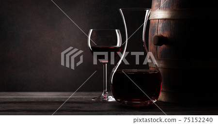 Wine decanter, glavss and old wooden barrel 75152240
