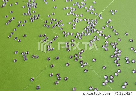 rhinestones on a green background, top photo. design for text rhinestones on a green background, top photo. design for text 75152424