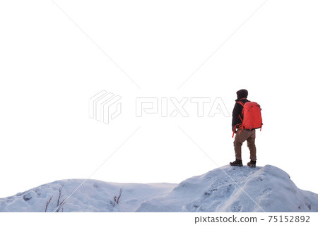 Man backpacker standing on snowy ridge 75152892