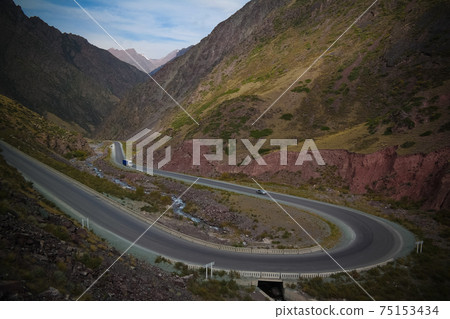 Serpentine road in Too-Ashuu pass and Kara Balta river and valley,Chuy Region of Kyrgyzstan Serpentine road in Too-Ashuu pass and Kara Balta river and valley,Chuy Region of Kyrgyzstan 75153434