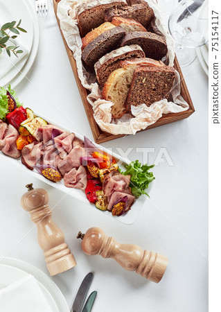 Sliced Beef or Pork with Marinated Vegetables and Sauce. Beautifully decorated catering banquet menu. Food snacks and appetizers for buffet on white background Sliced Beef or Pork with Marinated Vegetables and Sauce. Beautifully decorated catering banquet menu. Food snacks and appetizers for buffet on white background 75154117