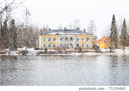 KOUVOLA, FINLAND - MARCH 21, 2019: Beautiful wooden Rabbelugn Manor - Takamaan Kartano. Wrede family house was built in 1820 on the river Kymijoki bank. KOUVOLA, FINLAND - MARCH 21, 2019: Beautiful wooden Rabbelugn Manor - Takamaan Kartano. Wrede family house was built in 1820 on the river Kymijoki bank. 75154865