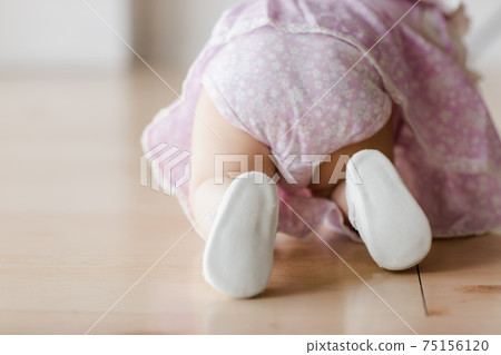 Funny crawling baby girl. Happy family concept  75156120