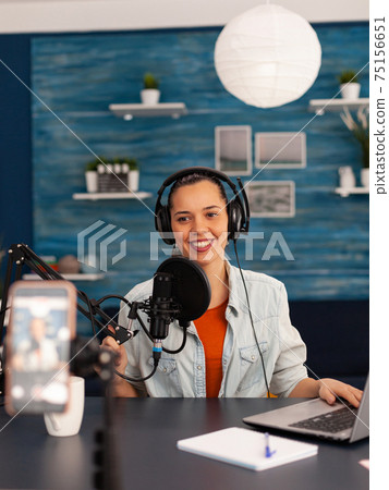 Social media star woman holding professional microphone while recording podcast for youtube channel 75156651