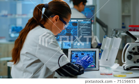 Scientist using digital tablet working in modern medical research laboratory 75156655