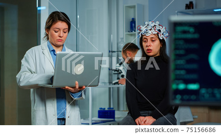 Team neurological doctors working together developing treatment Team neurological doctors working together developing treatment 75156686