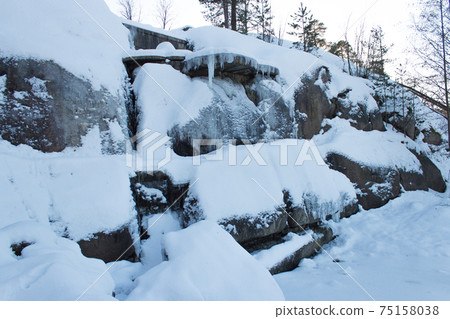 Frozen waterfall on rocks, Finland. Frozen waterfall on rocks, Finland. 75158038