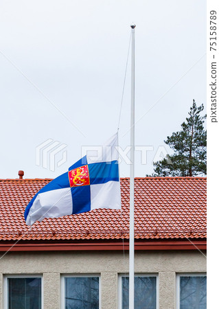 Finnish flag lowered to half mast on the occasion of mourning at cloudy autumn day Finnish flag lowered to half mast on the occasion of mourning at cloudy autumn day 75158789