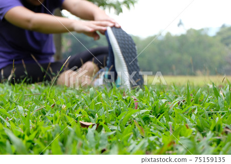 Young sporty woman workout before fitness training warming up in outdoors. Young sporty woman workout before fitness training warming up in outdoors. 75159135
