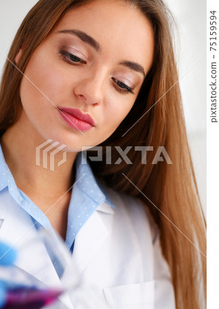 Technician hold in arms in protective gloves sample bottle 75159594