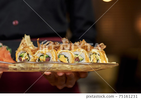 Close-up photo of appetizing set of sushi on plate 75161231