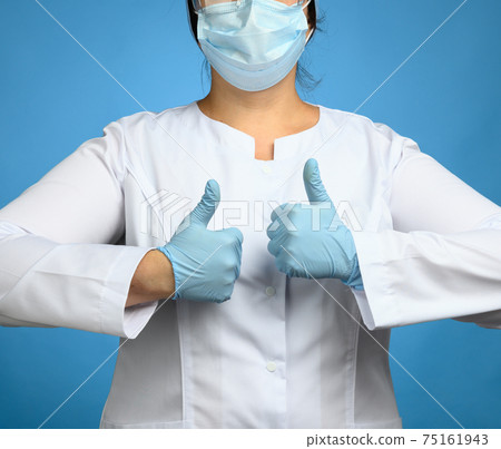 woman in white coat, wearing blue medical latex gloves on her hands, showing like gesture 75161943