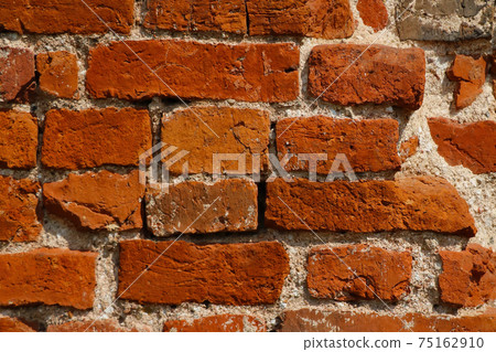 View of the wall of a red brick building. Background. 75162910