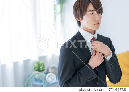 New employee wearing a tie at home in the morning New employee wearing a tie at home in the morning 75164788