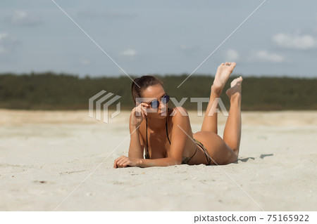 Seductive female resting on beach Seductive female resting on beach 75165922