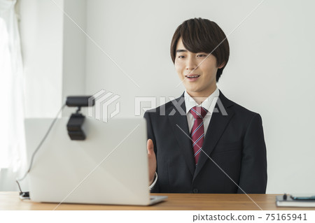 Young man speaking to webcam job hunting image Young man speaking to webcam job hunting image 75165941