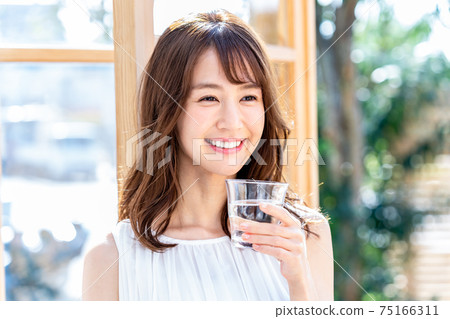 Young woman with a cup Young woman with a cup 75166311