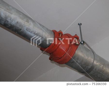 KAJANG, MALAYSIA -JUNE 16, 2017: Sprinkler system pipe in hang at the slab soffit. Sprinkler is an active fire fighting system in the building. KAJANG, MALAYSIA -JUNE 16, 2017: Sprinkler system pipe in hang at the slab soffit. Sprinkler is an active fire fighting system in the building. 75166330