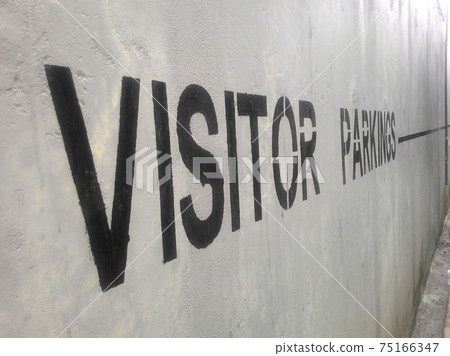 VISITOR PARKING sign at car park basement parking wall. 75166347