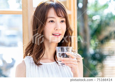 Young woman with a cup Young woman with a cup 75166414