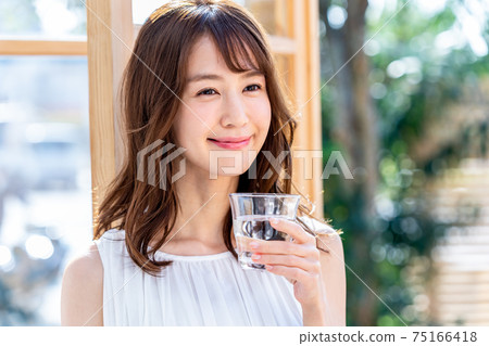 Young woman with a cup Young woman with a cup 75166418