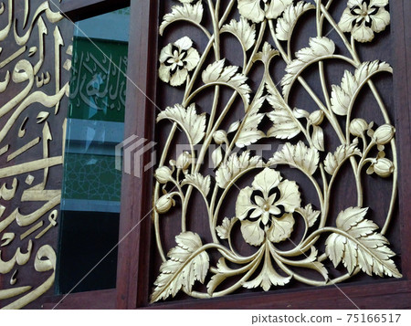 CYBERJAYA, MALAYSIA -JULY 04, 2017: Wood carving with floral motif. The carving was wrapped with gold leaves.  75166517