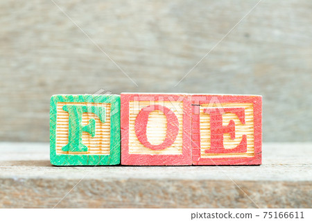 Color alphabet letter block in word foe on wood background 75166611