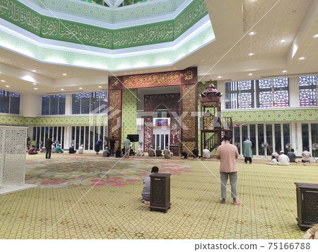 CYBERJAYA, MALAYSIA -17 JULY 2019: A group of Muslim men were praying inside the mosque. It is a common ritual for a Muslim. 75166788