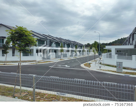 SEREMBAN, MALAYSIA -APRIL 15, 2020: New double story luxury terrace house under construction in Malaysia. Designed by an architect with a modern and contemporary style. SEREMBAN, MALAYSIA -APRIL 15, 2020: New double story luxury terrace house under construction in Malaysia. Designed by an architect with a modern and contemporary style. 75167368