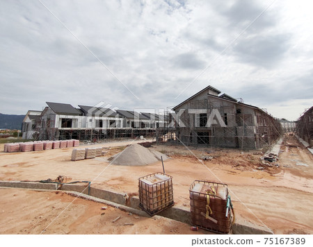 SEREMBAN, MALAYSIA -APRIL 15, 2020: New double story luxury terrace house under construction in Malaysia.  Designed by an architect with a modern and contemporary style. 75167389
