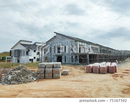 SEREMBAN, MALAYSIA -APRIL 15, 2020: New double story luxury terrace house under construction in Malaysia. Designed by an architect with a modern and contemporary style. SEREMBAN, MALAYSIA -APRIL 15, 2020: New double story luxury terrace house under construction in Malaysia. Designed by an architect with a modern and contemporary style. 75167392