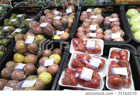 SEREMBAN, MALAYSIA -OCTOBER 09, 2017:  Fresh tropical fruit in plastic wrap and for sale. Packages is placed on the cold chiller shelf to last long. 75168570