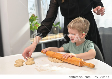 Mother With Toddler Son With Cochlear Implants Baking Donuts Mother With Toddler Son With Cochlear Implants Baking Donuts 75170463