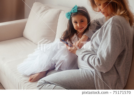Pregnant mom and her daughter waiting for baby Pregnant mom and her daughter waiting for baby 75171570