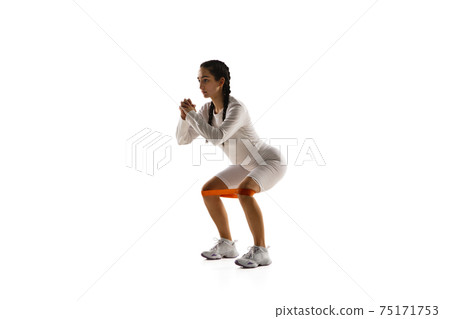 Young caucasian female model in action, motion isolated on white background. Concept of sport, movement, energy and dynamic, healthy lifestyle. Training, practicing. Young caucasian female model in action, motion isolated on white background. Concept of sport, movement, energy and dynamic, healthy lifestyle. Training, practicing. 75171753