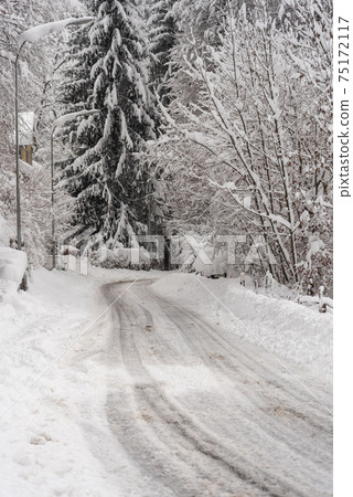Snowy, slippery roads after heavy snowfall Snowy, slippery roads after heavy snowfall 75172117