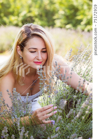 Woman posing outdoors at flowers market between hydrangea flowers 75172919