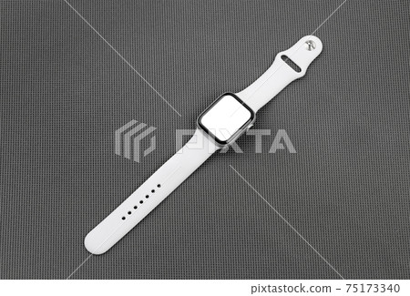 Smart watch with a blank white screen on a gray background. 75173340