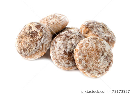 Gingerbread cookies on a white background. Homemade gingerbread cookies close-up. Gingerbread cookies on a white background. Homemade gingerbread cookies close-up. 75173537