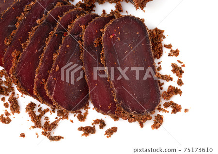 Jerky on a white background. Close-up of basturma sliced into pieces. Jerky on a white background. Close-up of basturma sliced into pieces. 75173610