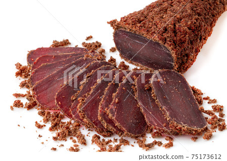 Jerky on a white background. Close-up of basturma sliced into pieces. Jerky on a white background. Close-up of basturma sliced into pieces. 75173612