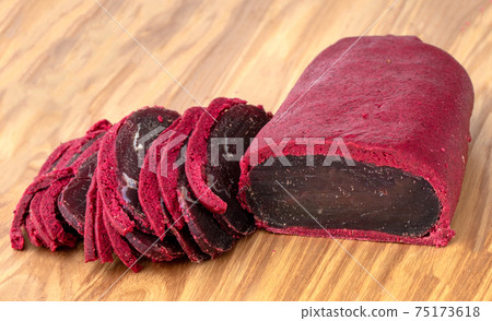 Cured meat on a wooden board. Close-up of basturma sliced into pieces. Cured meat on a wooden board. Close-up of basturma sliced into pieces. 75173618