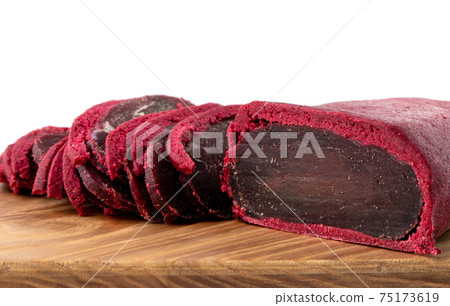 Cured meat on a wooden board. Close-up of basturma sliced into pieces. Cured meat on a wooden board. Close-up of basturma sliced into pieces. 75173619