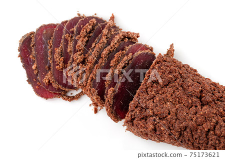 Jerky on a white background. Close-up of basturma sliced into pieces. Jerky on a white background. Close-up of basturma sliced into pieces. 75173621